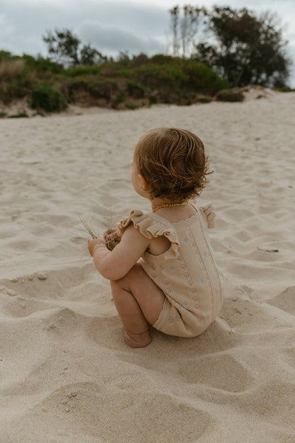 Sienna Ruffle Knit Pointelle Romper | Coastal Beige | WYLDE.